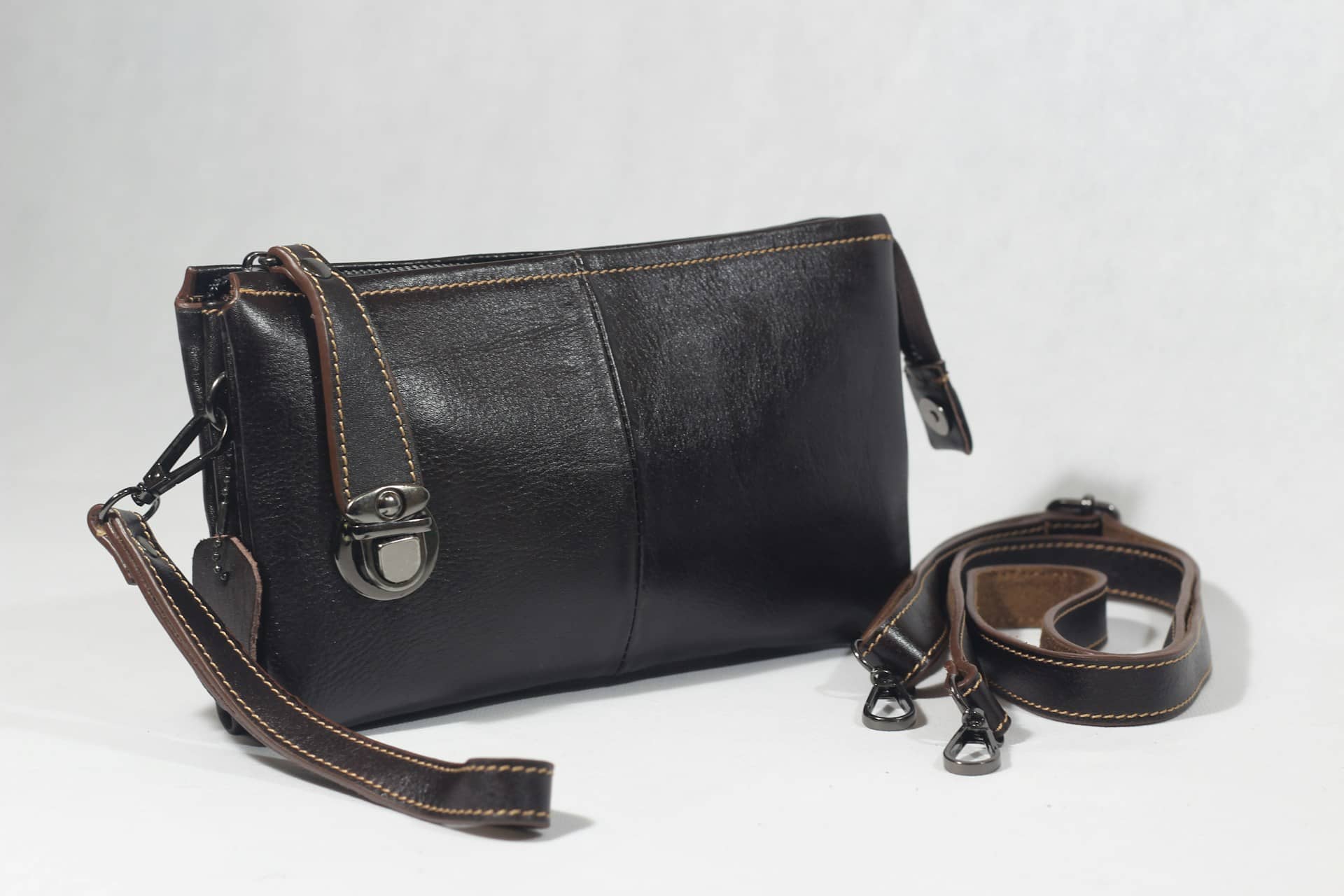 Black Handbag and detached straps beside it